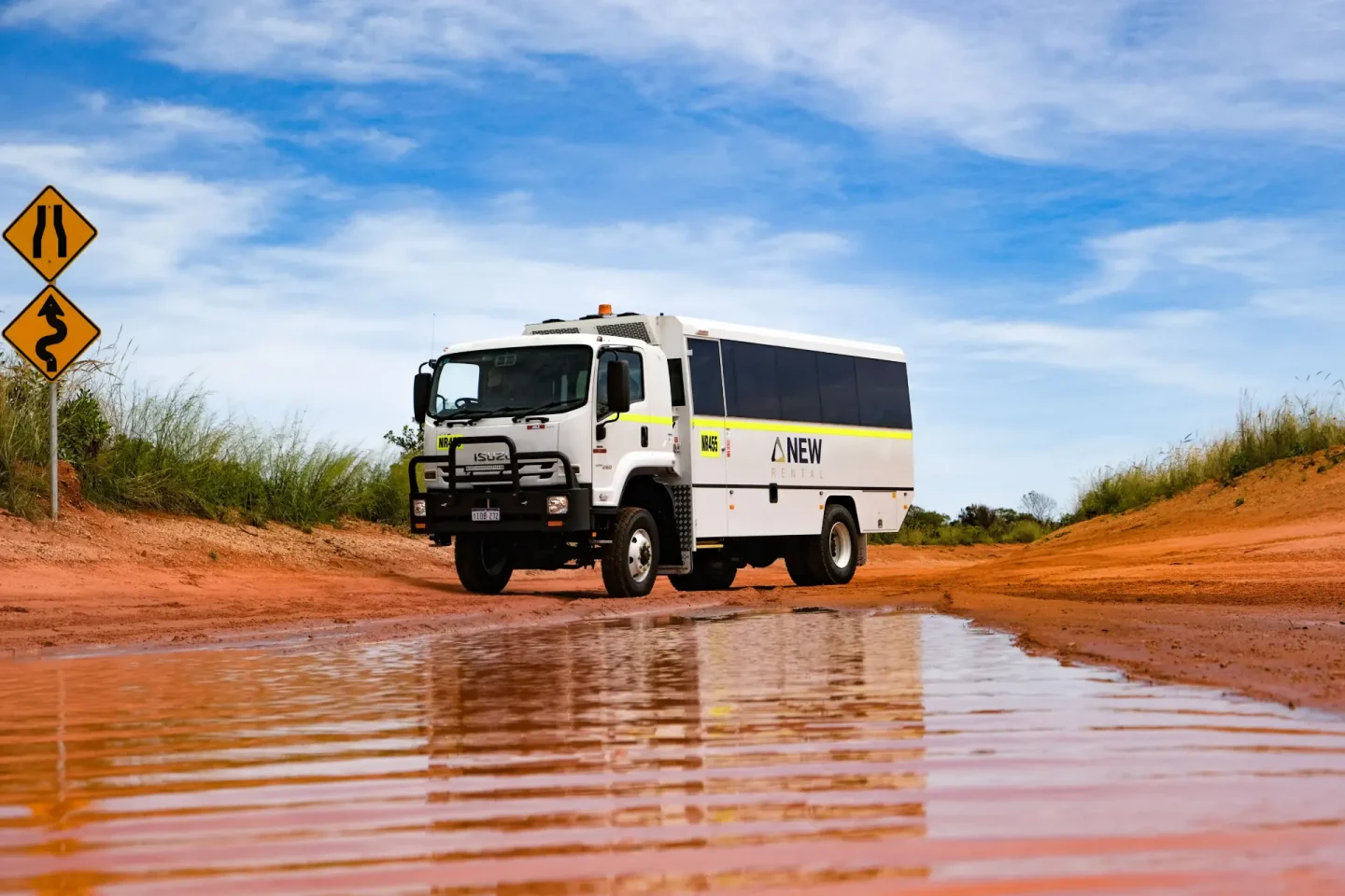 off road vehicle approaching large puddle in the outback