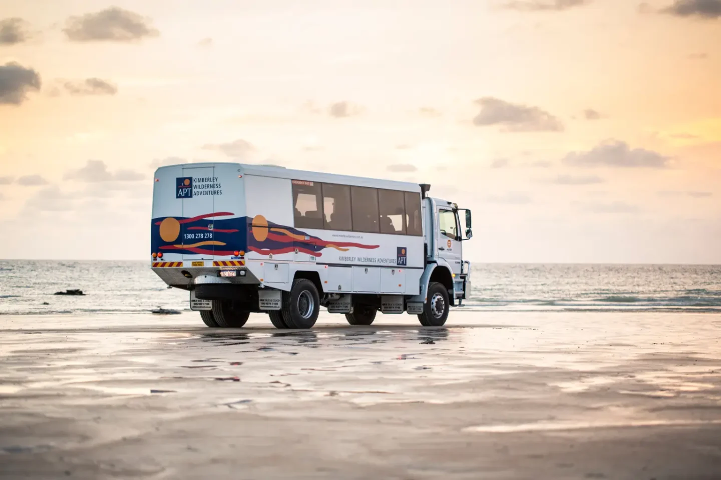 off road coach driving along beach