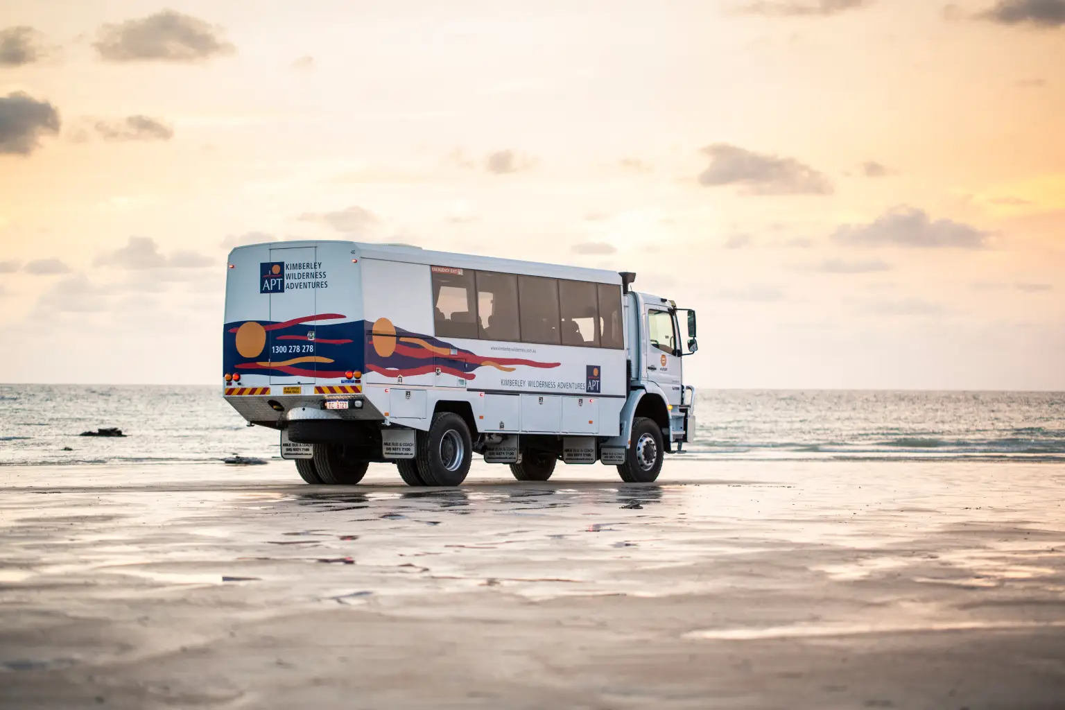 off road coach driving along beach