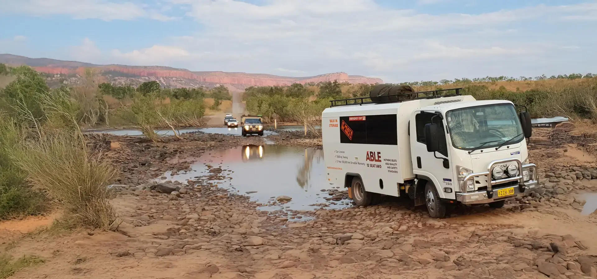 12 seater coach moving out of puddle