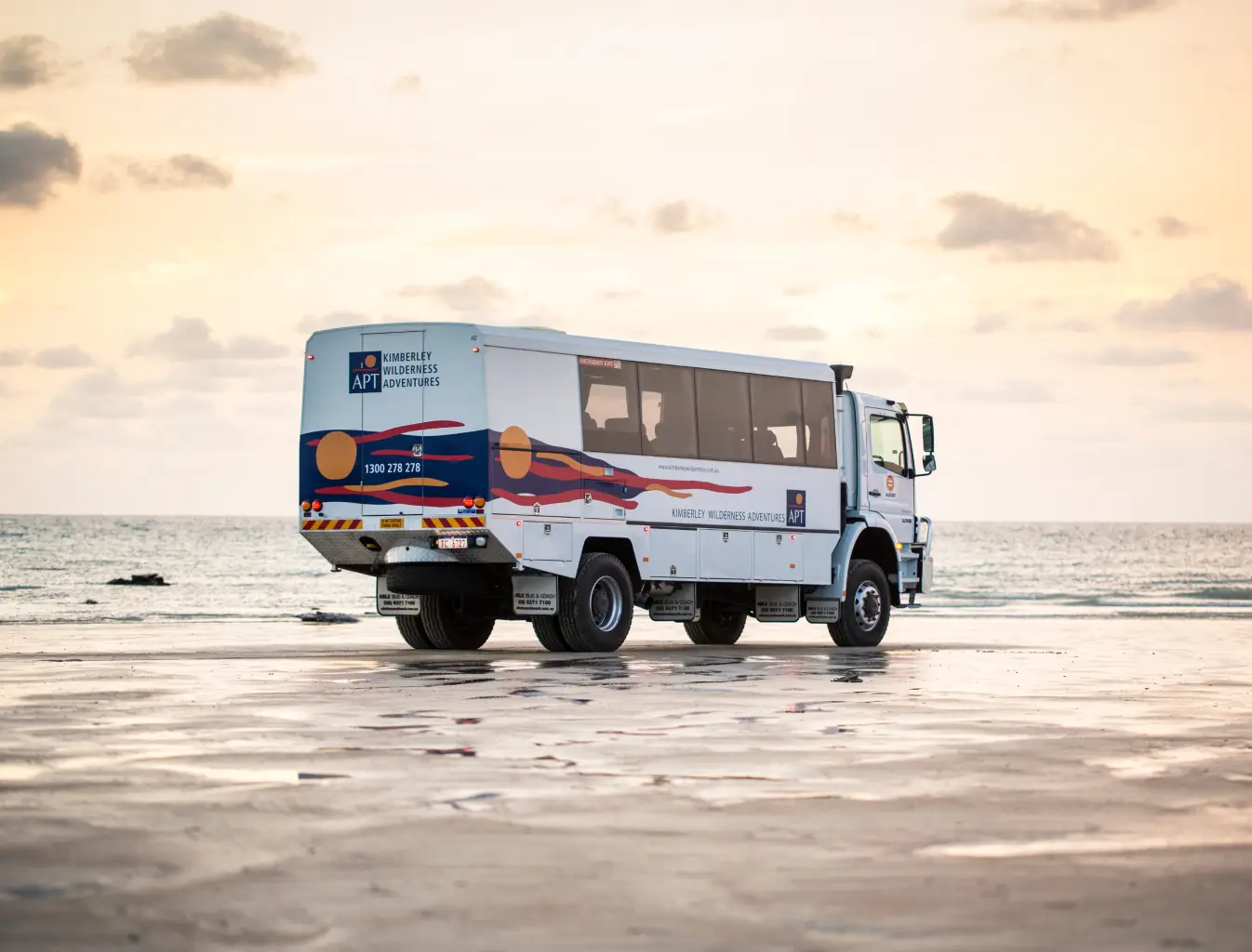 off road coach driving along beach